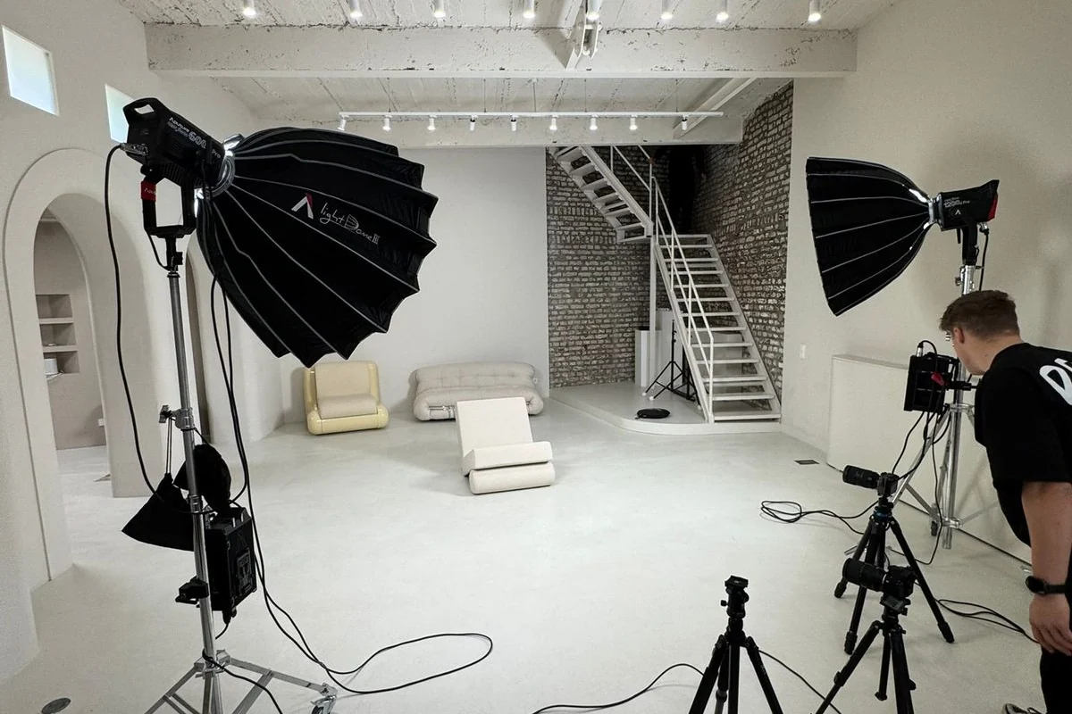 Helles Fotostudio mit Softboxen, Kameraequipment und vorbereitetem Set